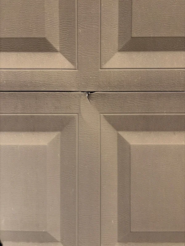 Close-up of a dented garage door panel