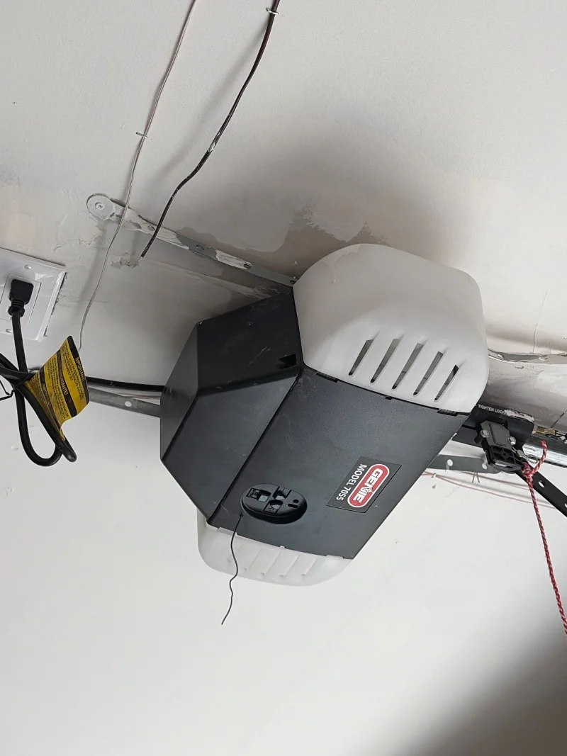 Wall-mount garage door opener beside the torsion bar